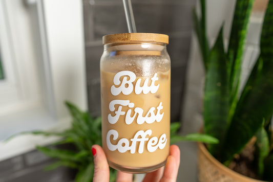But first coffee saying on a clear glass cup with bamboo lid and straw, filled with iced coffee, with white font, 16oz beer can glass, trendy glassware, fun coffee lover gift