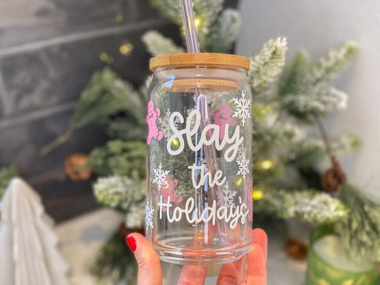 slay the holidays cute christmas glass cup, fun christmas cup with pink gingerbread men and white snowflakes with bamboo lid and straw, help in hand with christmas decor background, 16oz iced coffee cup
